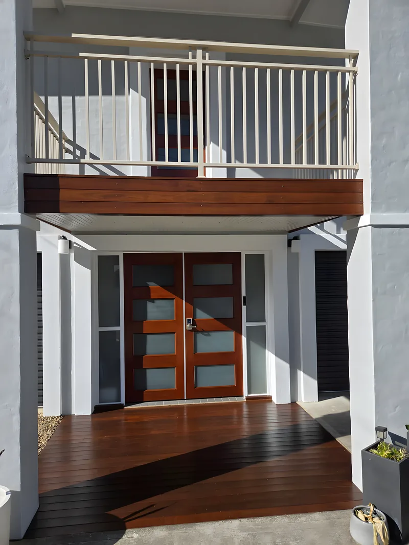 A restored merbau deck and timber entry doors