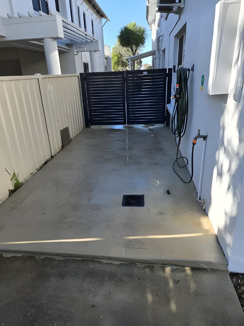 A bare concrete driveway before coating