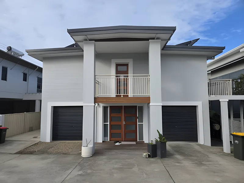 A freshly painted white rendered townhouse